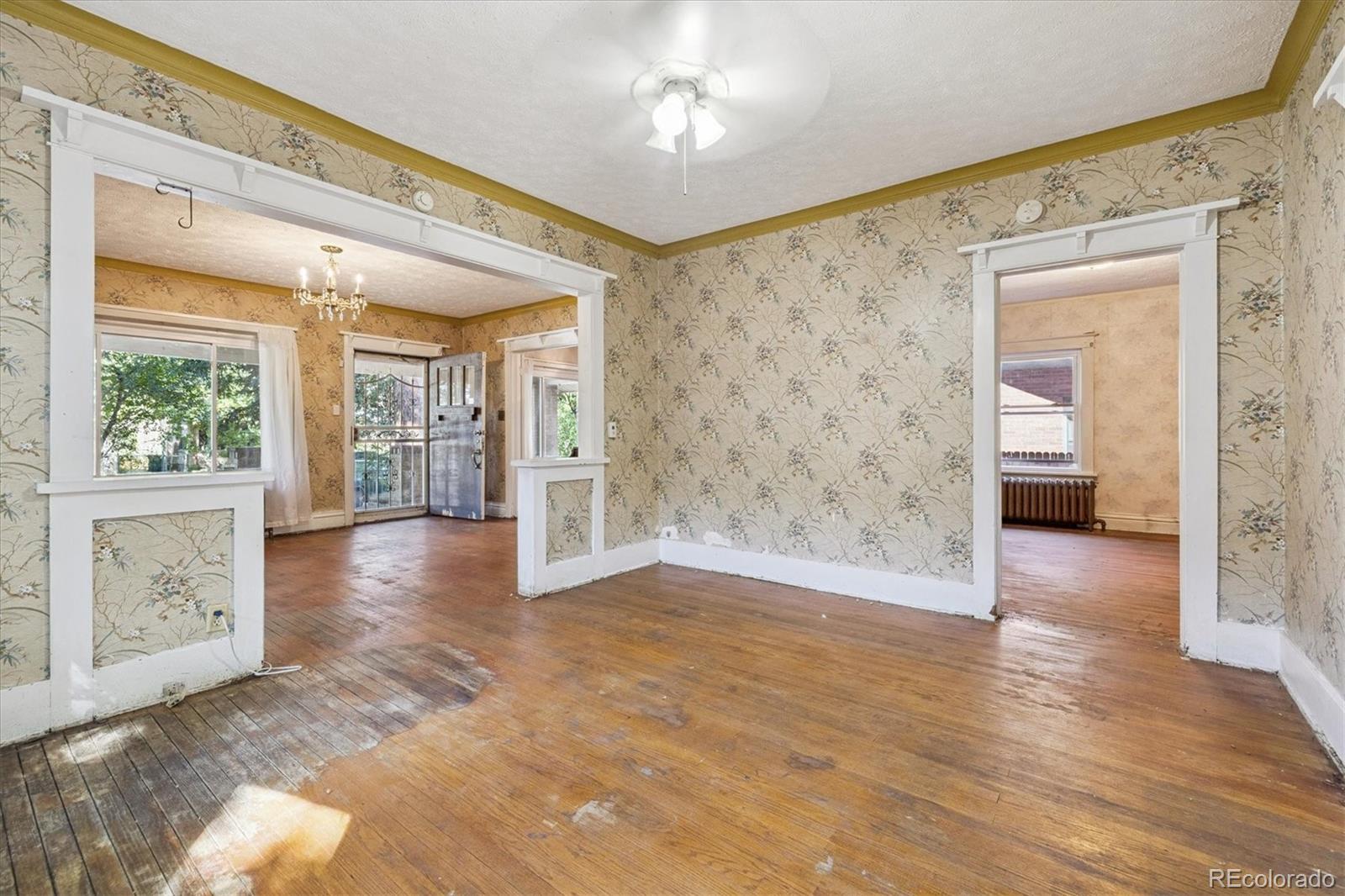 2510 Cherry Street Denver, CO 80207 - Photo 24 of 45 a view of an entryway with wooden floor and a living room