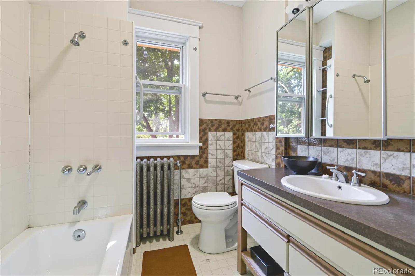 2510 Cherry Street Denver, CO 80207 - Photo 27 of 45 a bathroom with a sink and a mirror