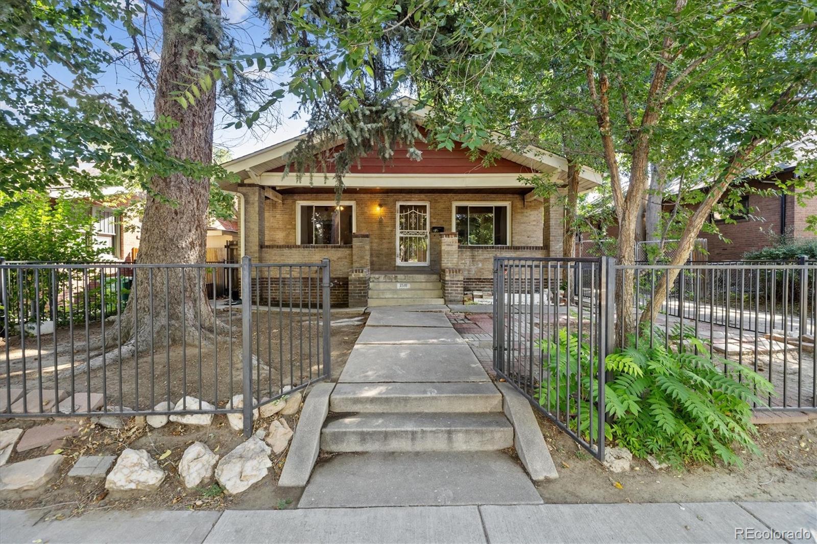 2510 Cherry Street Denver, CO 80207 - Photo 3 of 45 a front view of a house with a garden