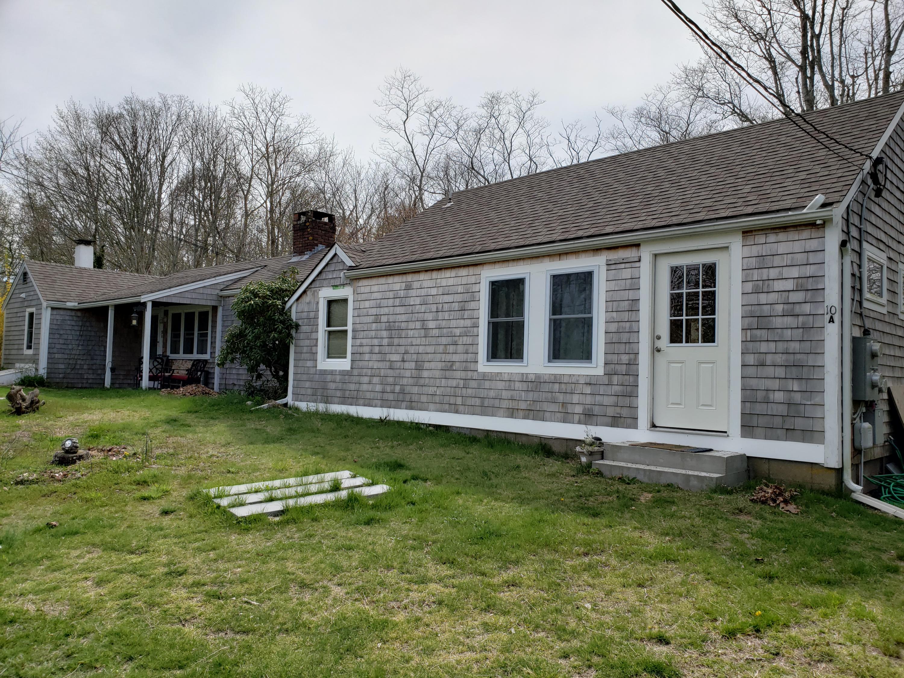 10 Childs Homestead Road Orleans, MA 02653 - Photo 2 of 23 a backyard of a house with a garden and barbeque oven