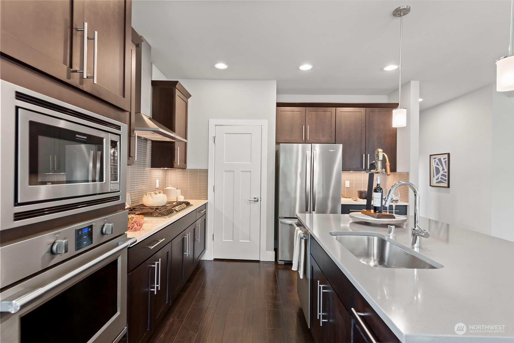 14 176th Place Southeast Bothell, WA 98012 - Photo 5 of 30 a kitchen with kitchen island granite countertop stainless steel appliances and sink