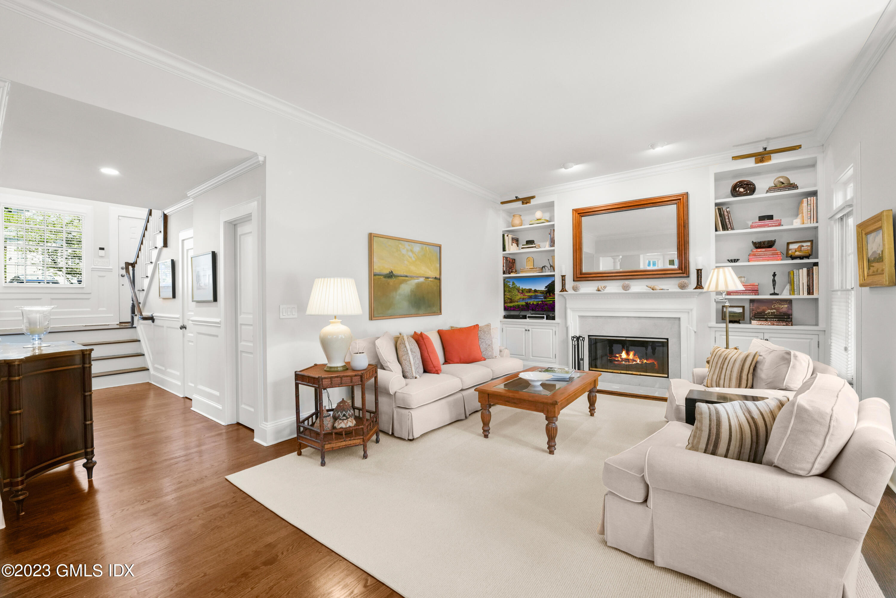 a living room with furniture a fireplace and a flat screen tv