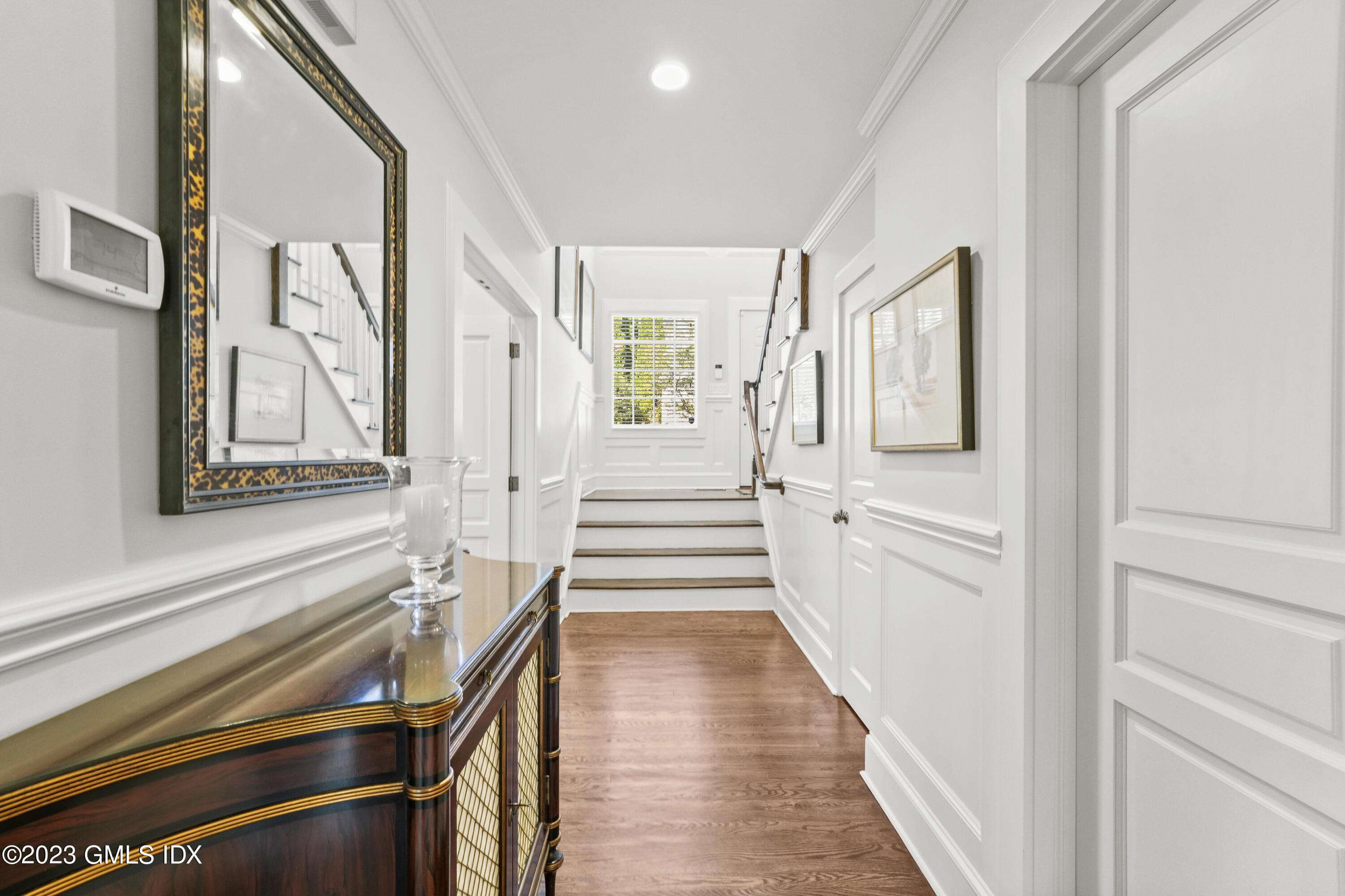 48 Spring Street, Unit 14 Greenwich, CT 06830 - Photo 12 of 29 a view of a hallway with wooden floor and staircase