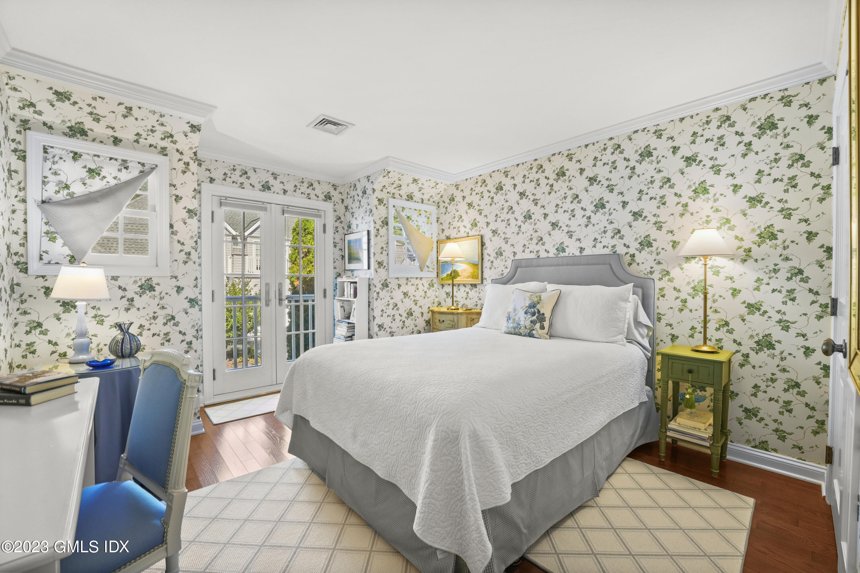 48 Spring Street, Unit 14 Greenwich, CT 06830 - Photo 18 of 29 a bedroom with a bed and a painting on the wall