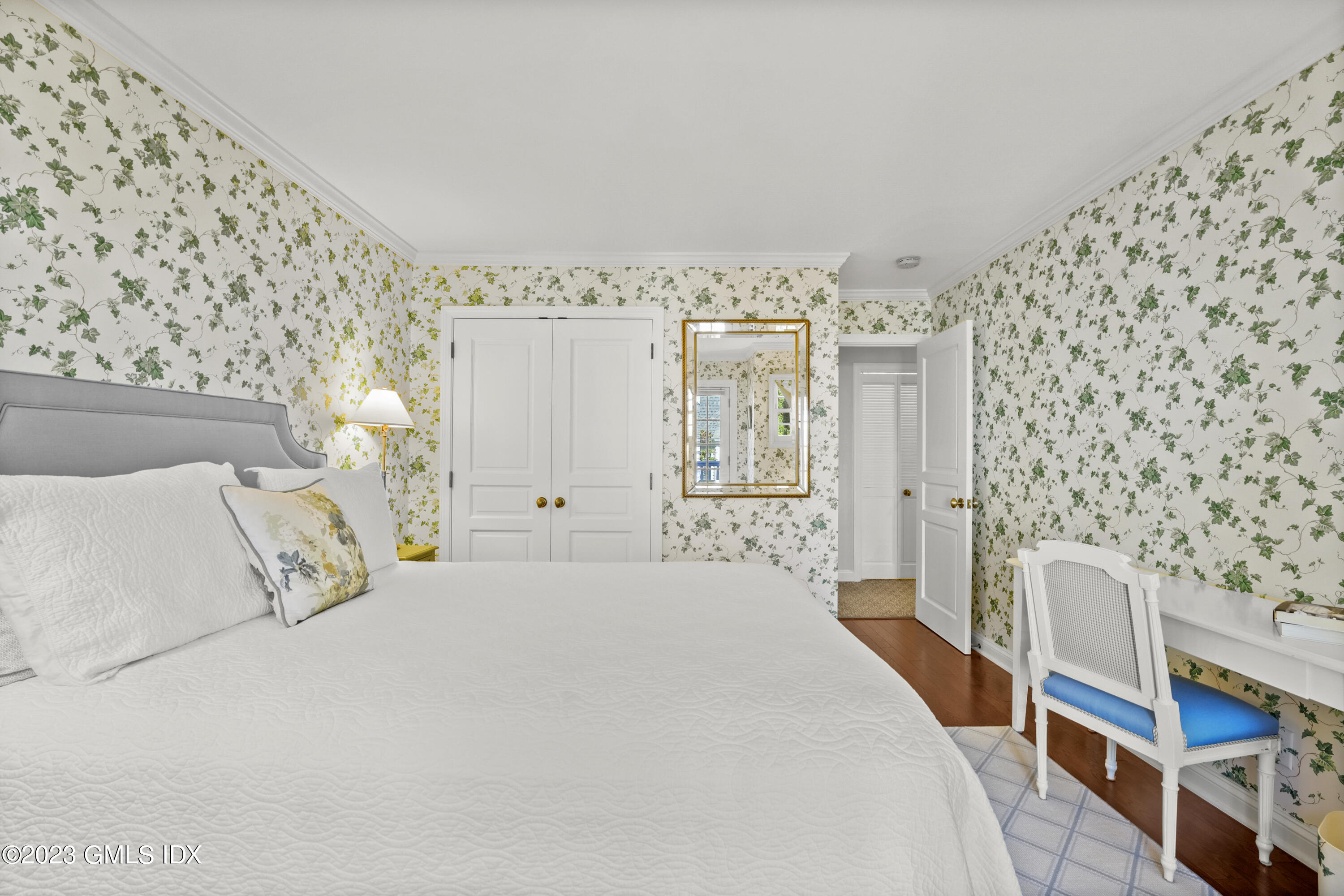 48 Spring Street, Unit 14 Greenwich, CT 06830 - Photo 19 of 29 a bedroom with a bed and a lamp on the dresser