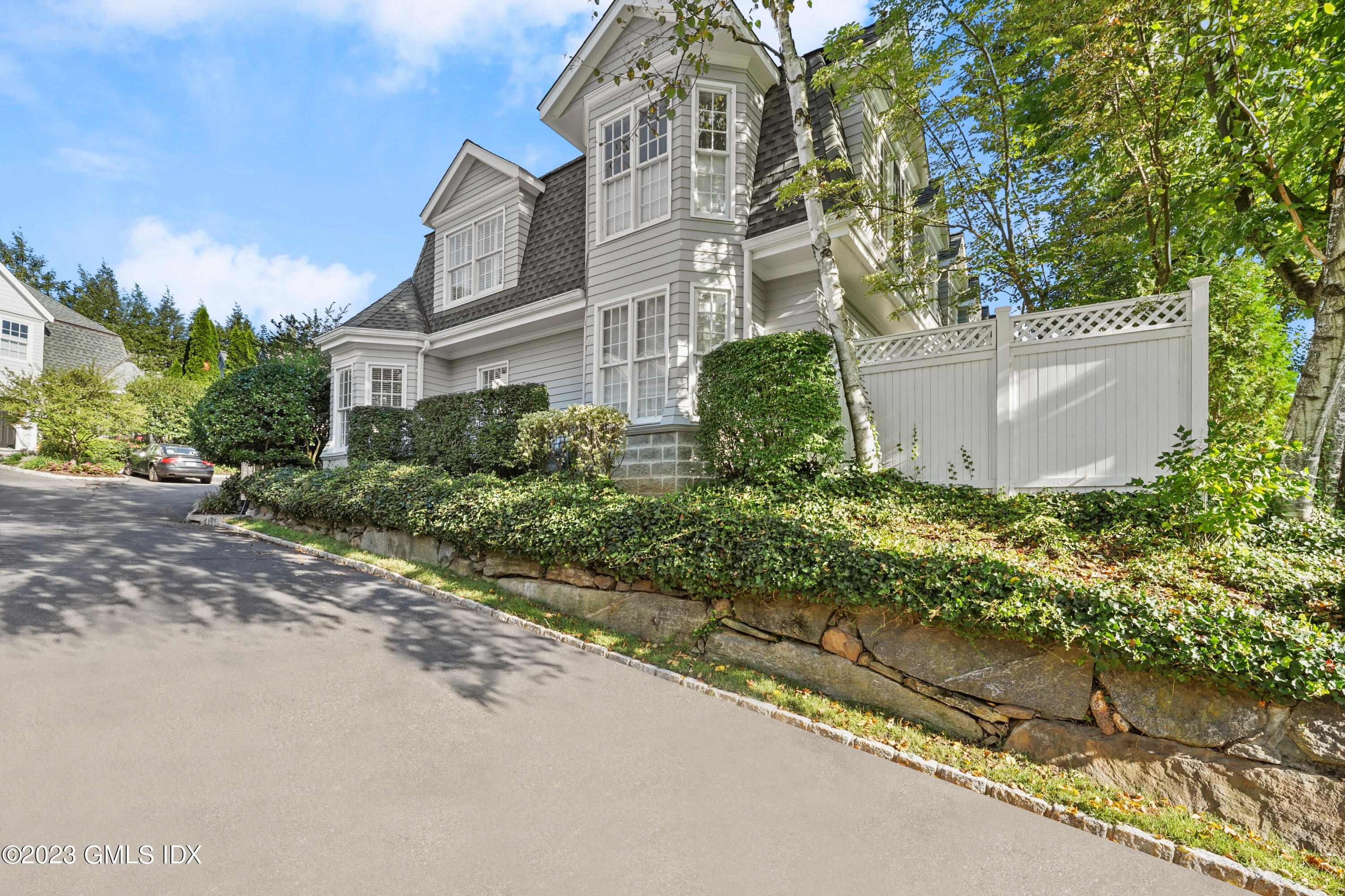 48 Spring Street, Unit 14 Greenwich, CT 06830 - Photo 23 of 29 front view of a house with a yard