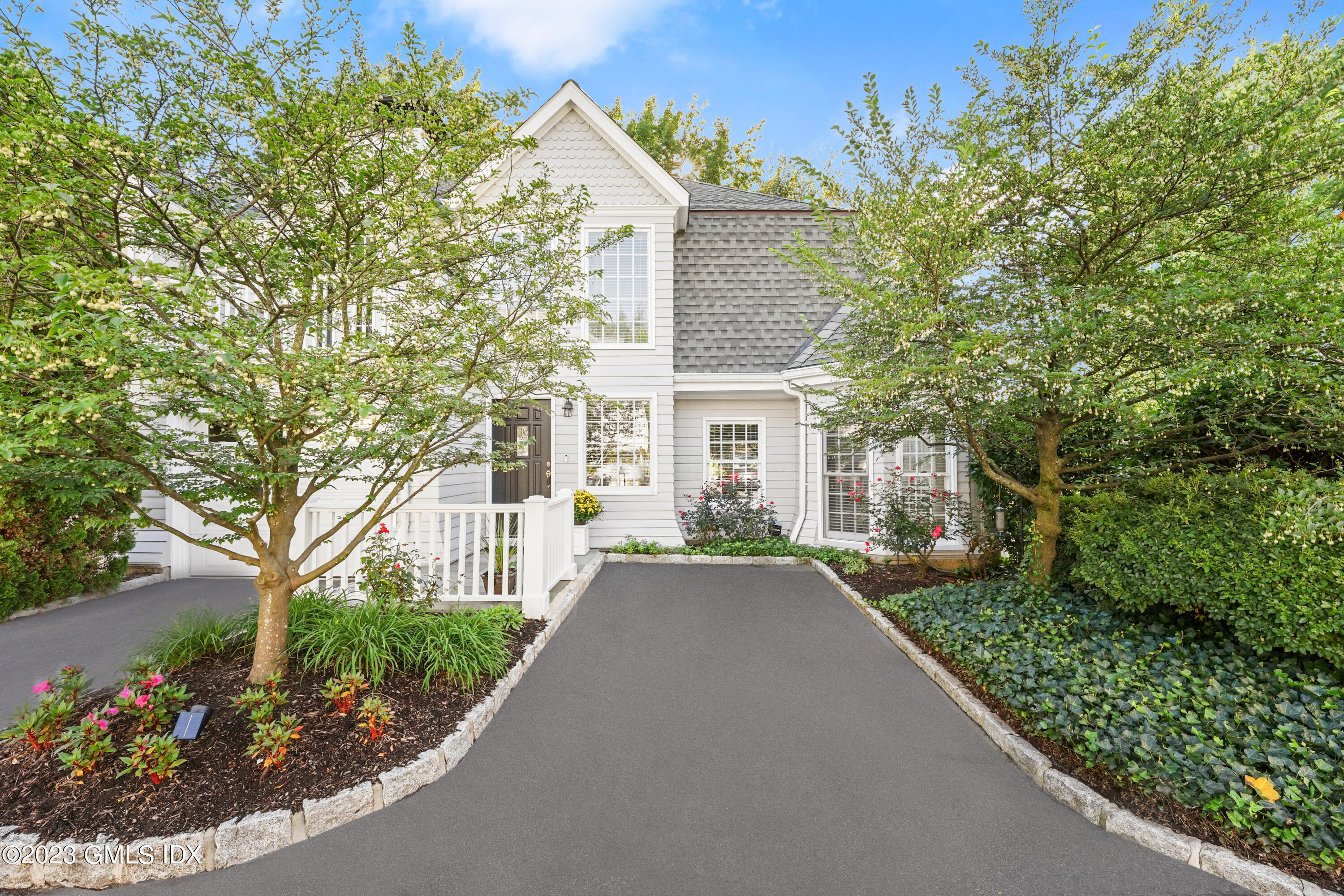 48 Spring Street, Unit 14 Greenwich, CT 06830 - Photo 24 of 29 a front view of a house with a garden