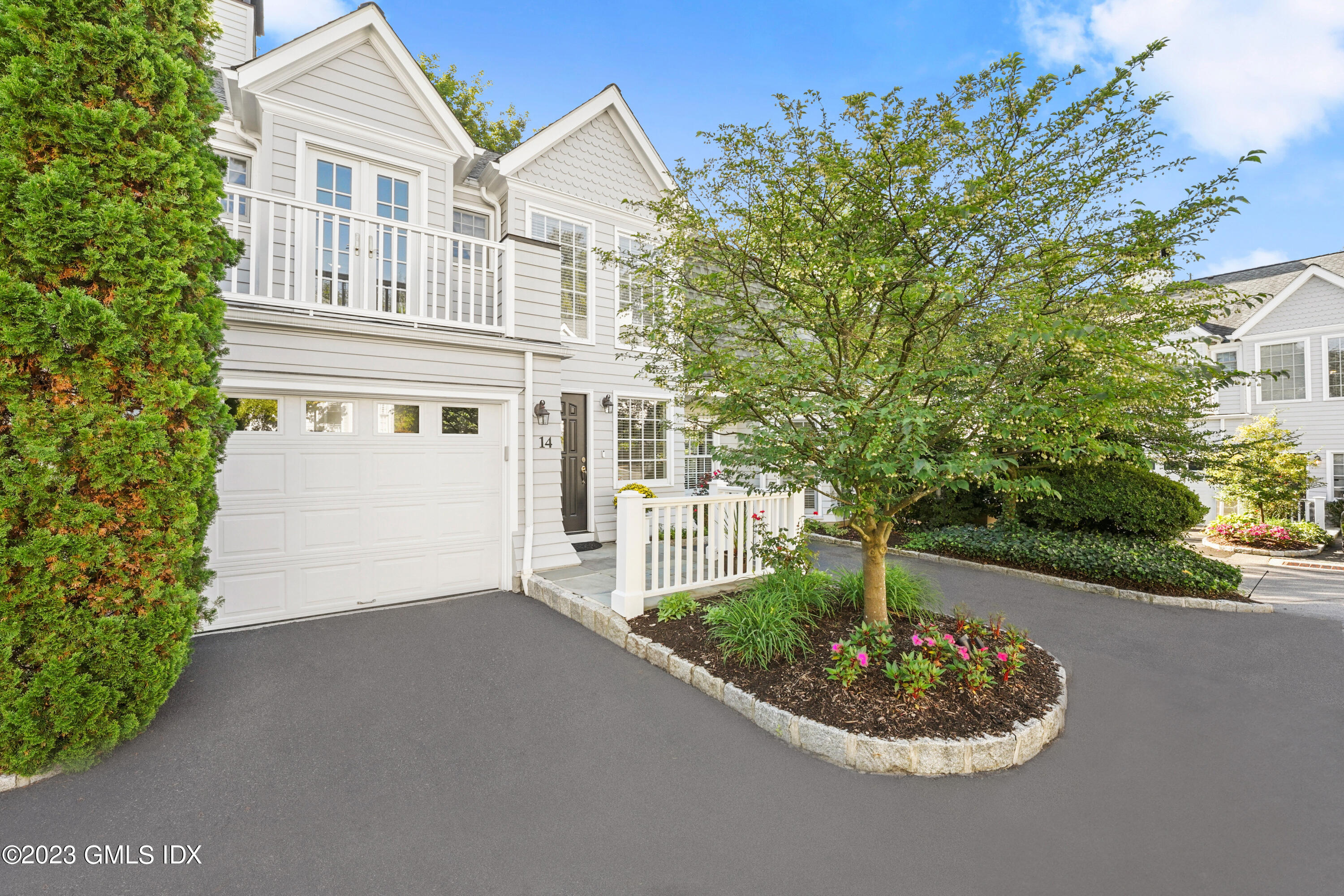 48 Spring Street, Unit 14 Greenwich, CT 06830 - Photo 25 of 29 a front view of a house with a garden