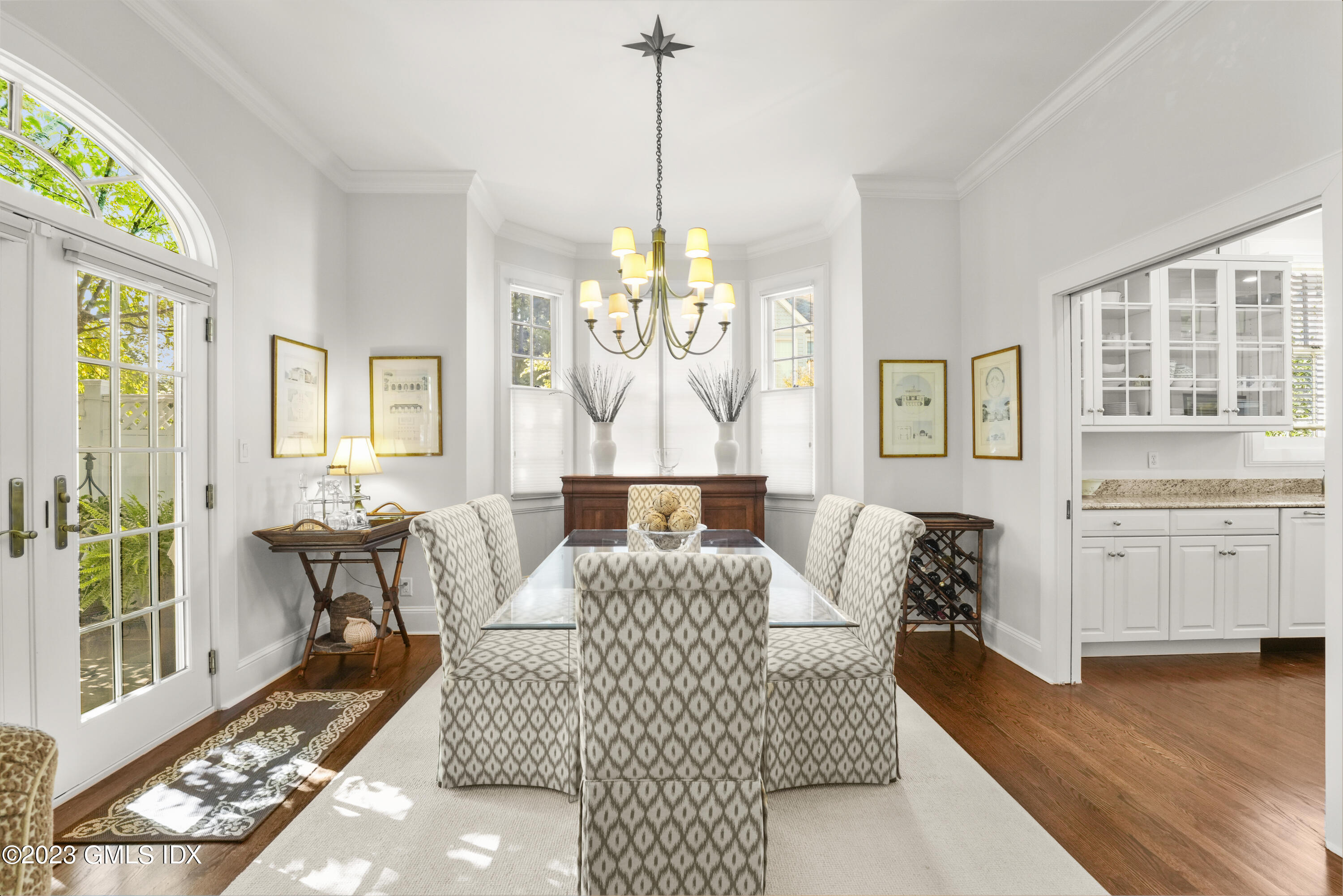 48 Spring Street, Unit 14 Greenwich, CT 06830 - Photo 4 of 29 a living room with furniture and a chandelier