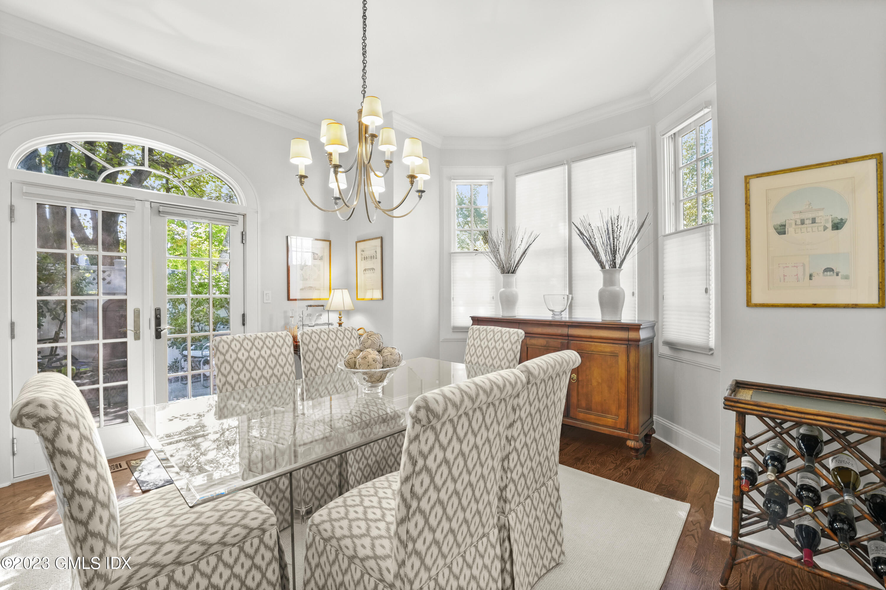 48 Spring Street, Unit 14 Greenwich, CT 06830 - Photo 5 of 29 a view of a dining room with furniture a chandelier and wooden floor
