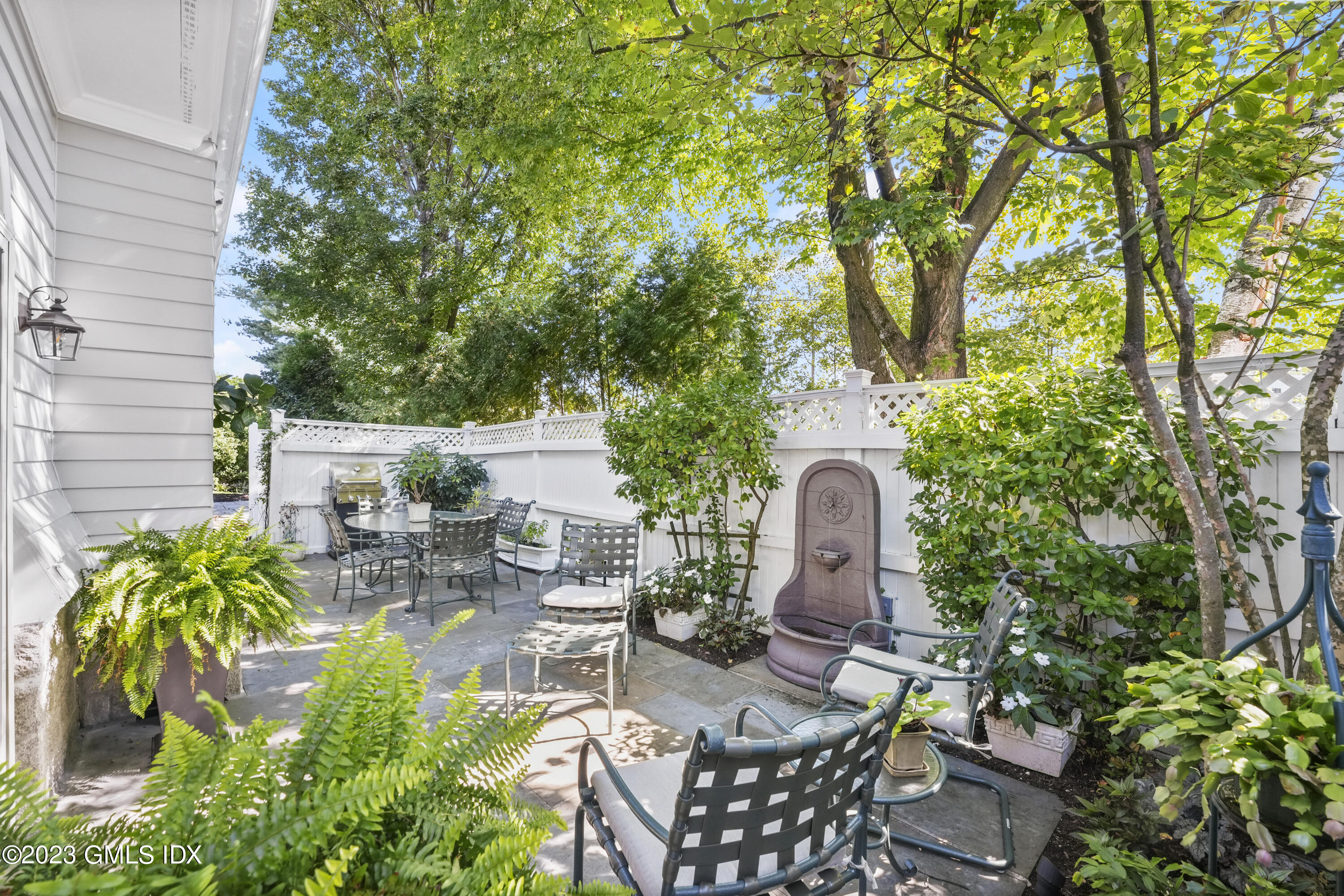 48 Spring Street, Unit 14 Greenwich, CT 06830 - Photo 7 of 29 a backyard of a house with seating space