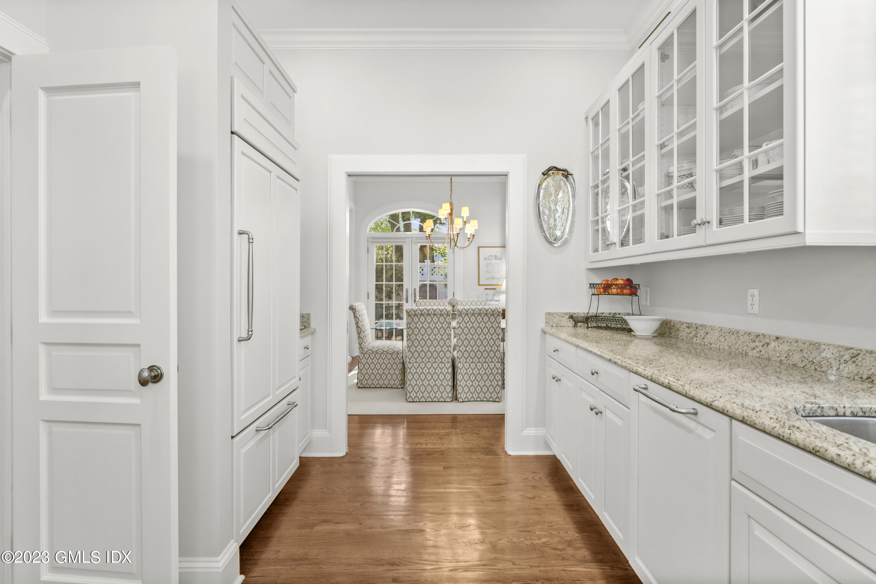 48 Spring Street, Unit 14 Greenwich, CT 06830 - Photo 9 of 29 a large white kitchen with granite countertop a sink and dishwasher a refrigerator with wooden floor