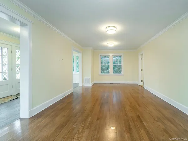 wooden floor in an empty room with a window