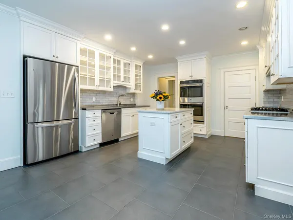 a kitchen with stainless steel appliances a refrigerator sink and microwave