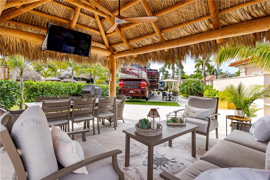 13595 Snook Circle Naples, FL 34114 - Photo 16 of 35 a view of a chairs and tables in a patio