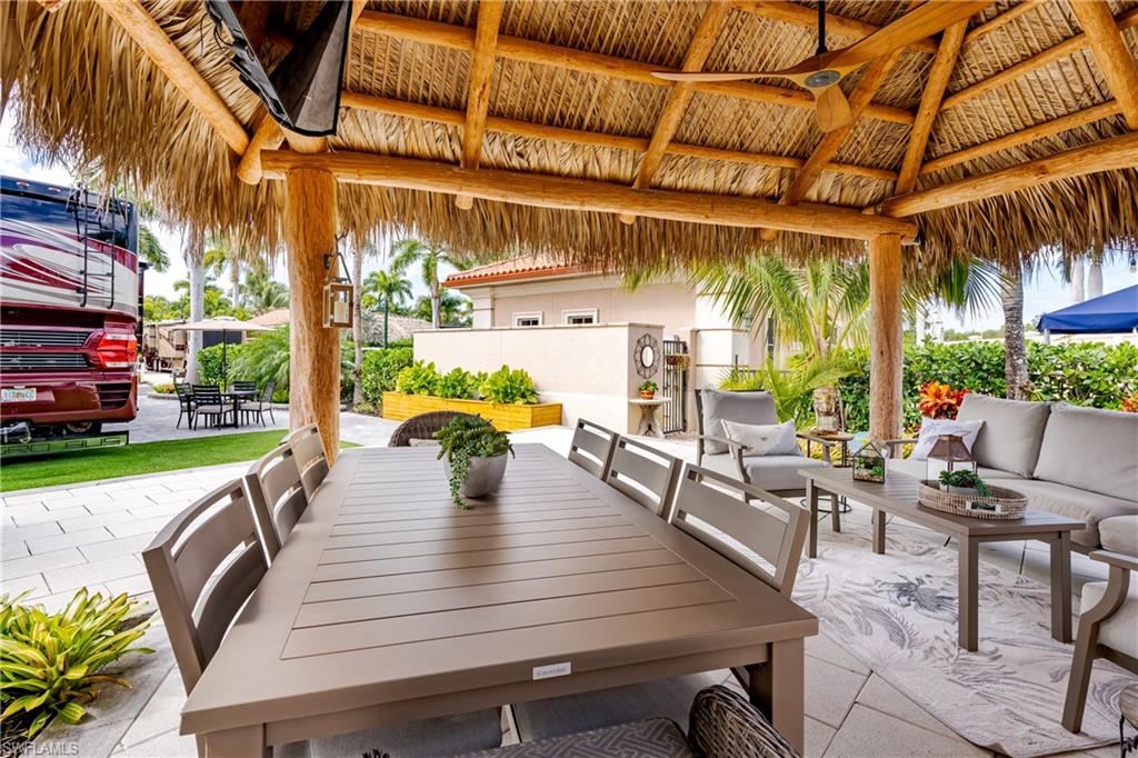 13595 Snook Circle Naples, FL 34114 - Photo 18 of 35 a view of a patio with couches table and chairs and potted plants
