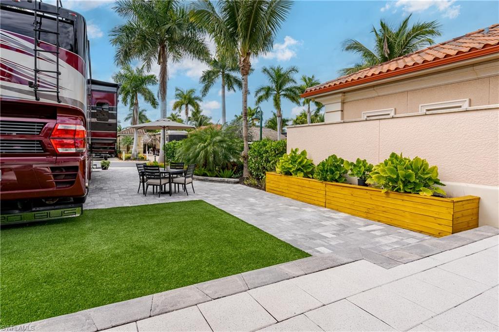 13595 Snook Circle Naples, FL 34114 - Photo 20 of 35 a swimming pool with outdoor seating and yard