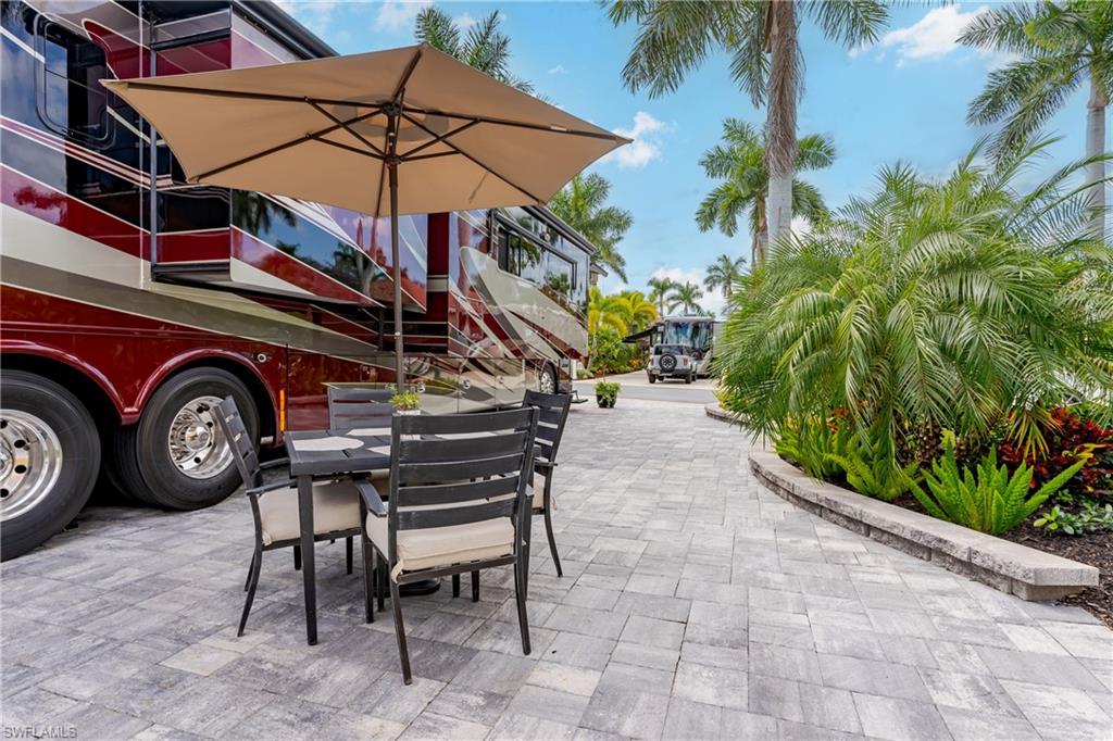13595 Snook Circle Naples, FL 34114 - Photo 21 of 35 a view of a chairs and table in patio