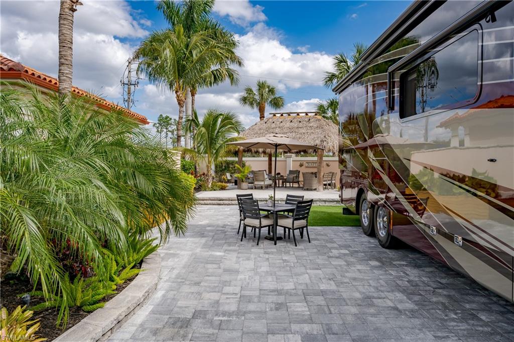 13595 Snook Circle Naples, FL 34114 - Photo 5 of 35 a view of a patio with a table and chairs under an umbrella