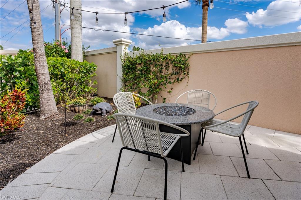 13595 Snook Circle Naples, FL 34114 - Photo 9 of 35 a table and chairs in a patio