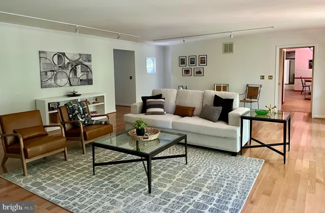 a living room with furniture and wooden floor