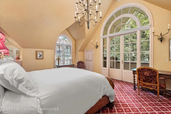 a spacious bedroom with a bed and a large window