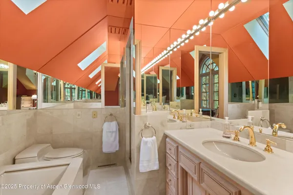 a bathroom with a toilet sink and mirror