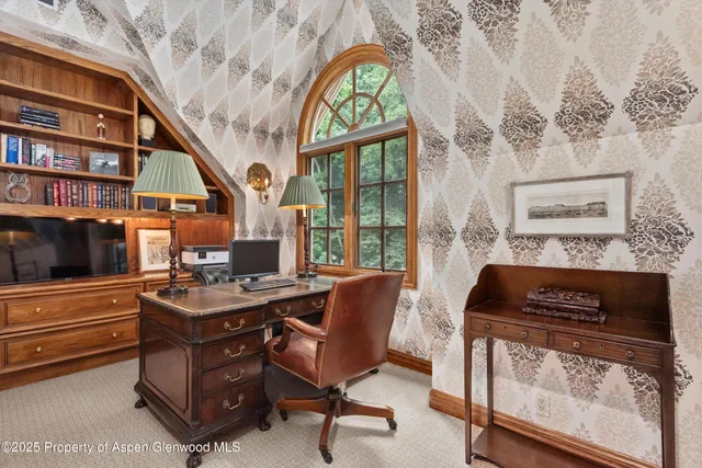 a living room with furniture a flat screen tv and a floor to ceiling window