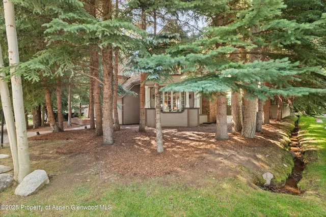a view of a house with a tree
