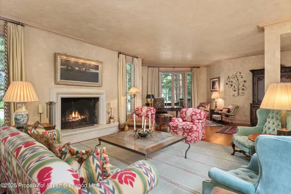 a living room with furniture fireplace and window