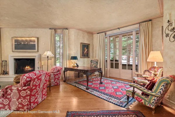 a living room with furniture and a floor to ceiling window