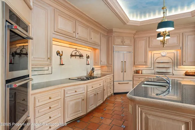 a kitchen with cabinets appliances a sink and a window