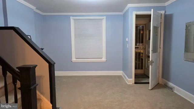 a front view of a building with retail shops and traffic signal