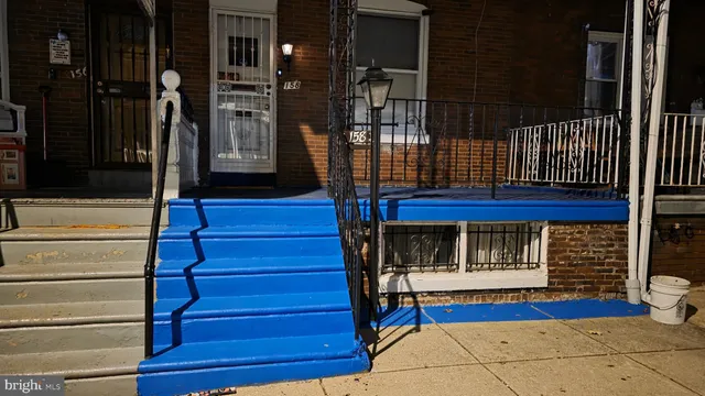 a view of a hallway with wooden floor and stairs