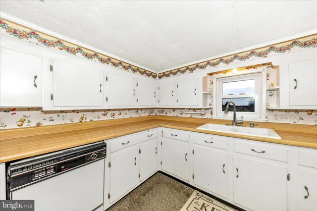a view of walk in closet with living room