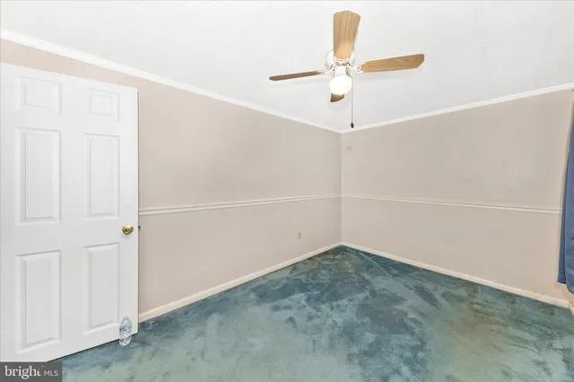 a view of a hallway with wooden floor and windows