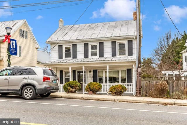 a view of a house with a wooden fence