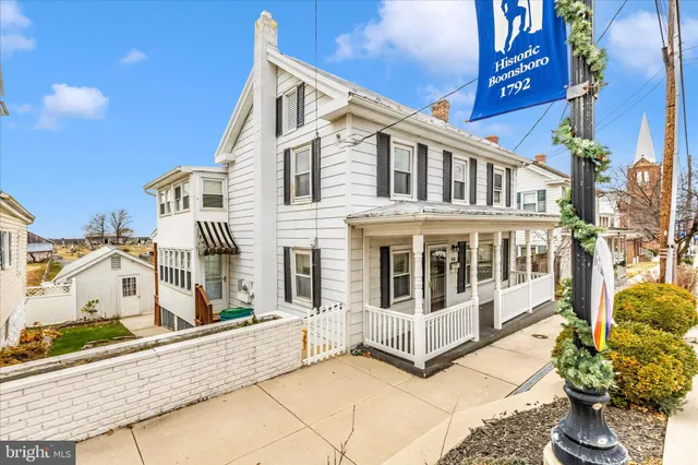 a view of a house with wooden fence