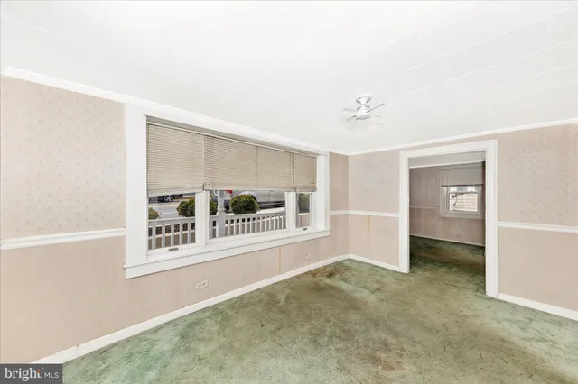 an empty room with windows and closet