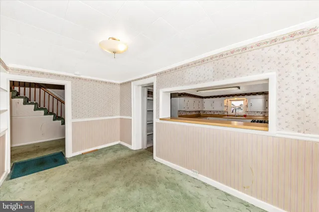 a view of a kitchen with a sink and cabinets