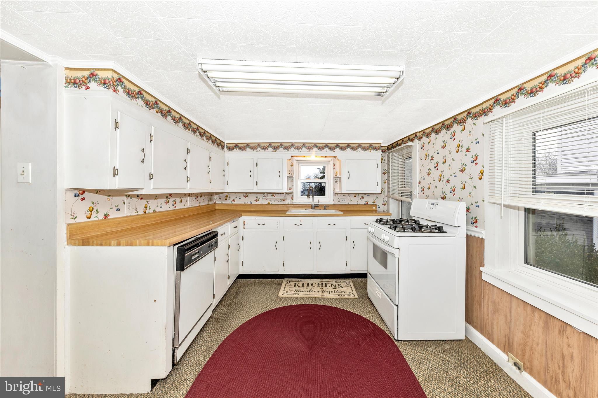 108 South Main Street Boonsboro, MD 21713 - Photo 10 of 50 a kitchen with a stove a sink and a refrigerator