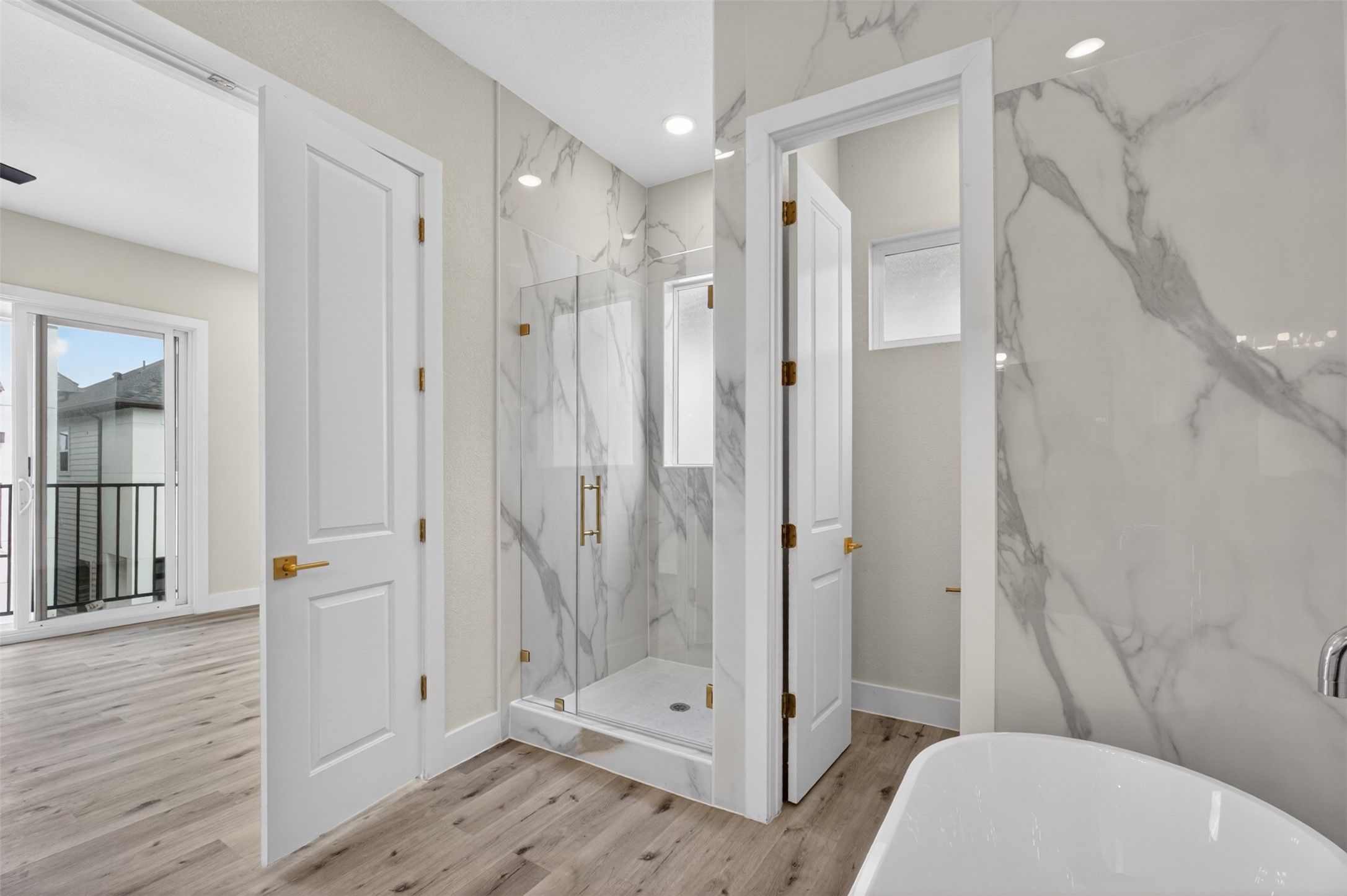 5906 St Augustine Street, Unit F Houston, TX 77021 - Photo 17 of 34 rimary bathroom angle showing the freestanding tub, separate shower, and adjacent bedroom access.