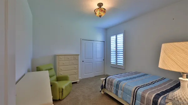 a bedroom with two beds and a chandelier