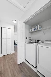a utility room with cabinets washer and dryer