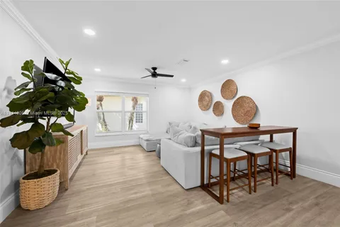 a living room with furniture and a potted plant