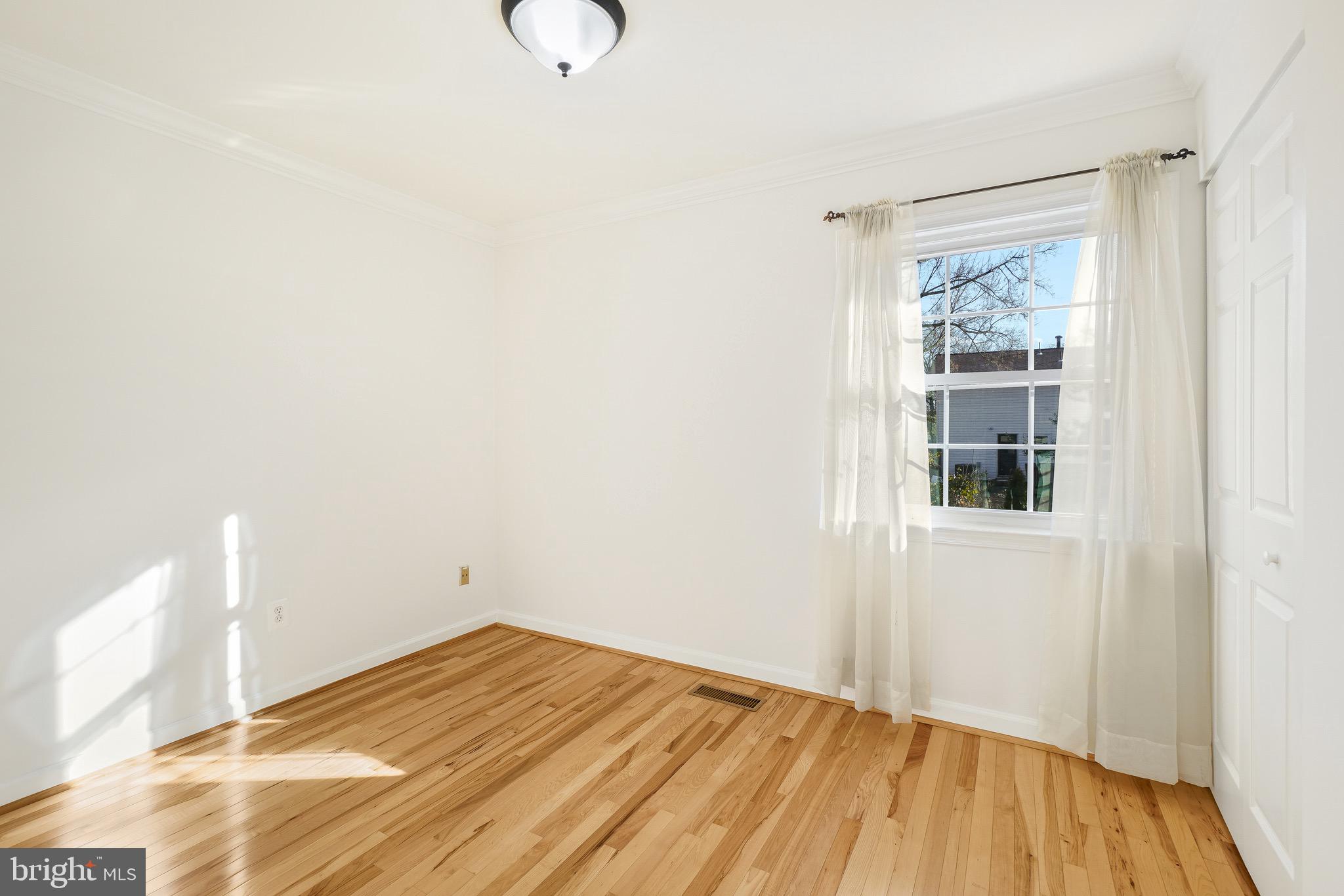 4712 Listra Road Rockville, MD 20853 - Photo 17 of 30 a view of empty room with wooden floor and fan