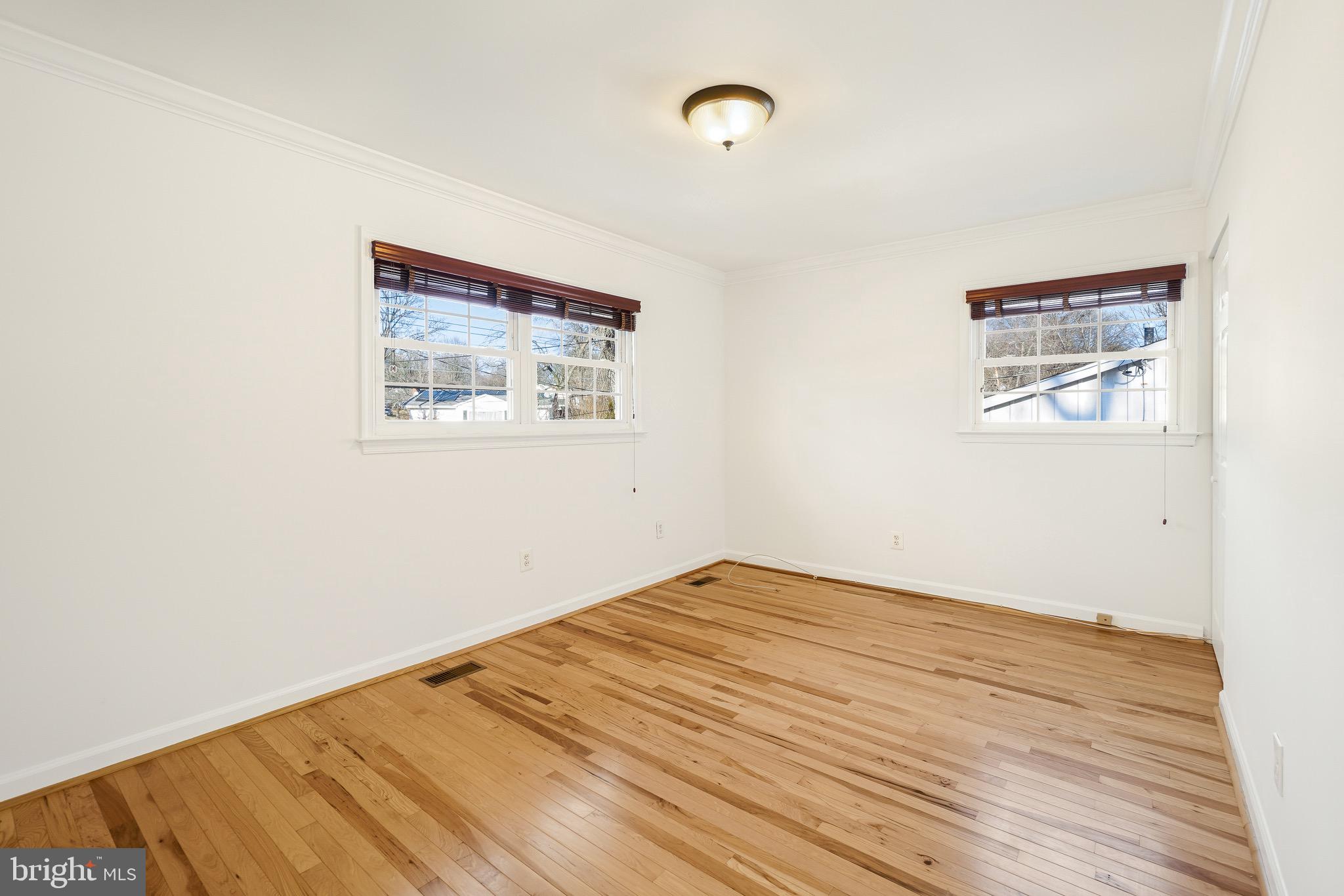 4712 Listra Road Rockville, MD 20853 - Photo 18 of 30 an empty room with wooden floor and windows
