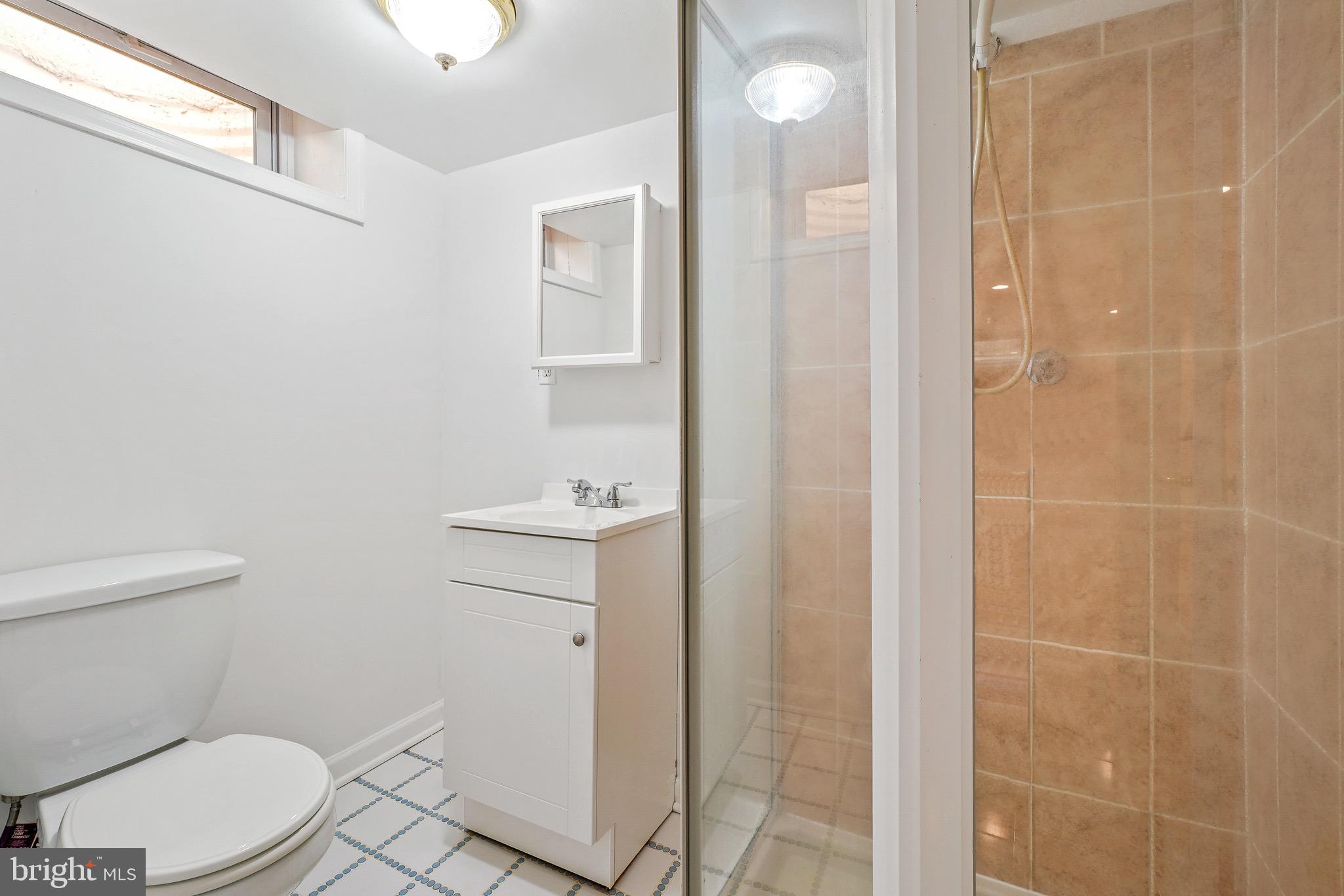 4712 Listra Road Rockville, MD 20853 - Photo 24 of 30 a white toilet sitting next to a bathroom sink