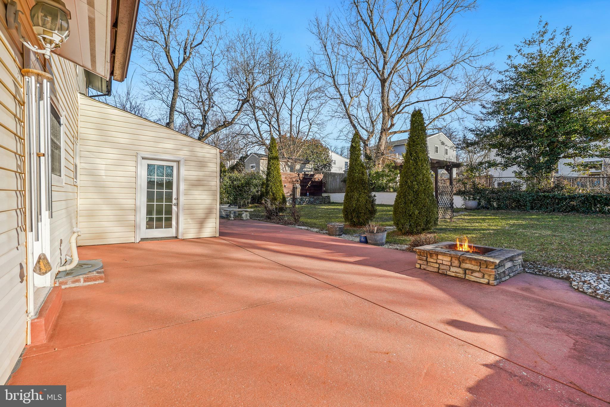 4712 Listra Road Rockville, MD 20853 - Photo 26 of 30 a backyard of a house with large trees and outdoor seating
