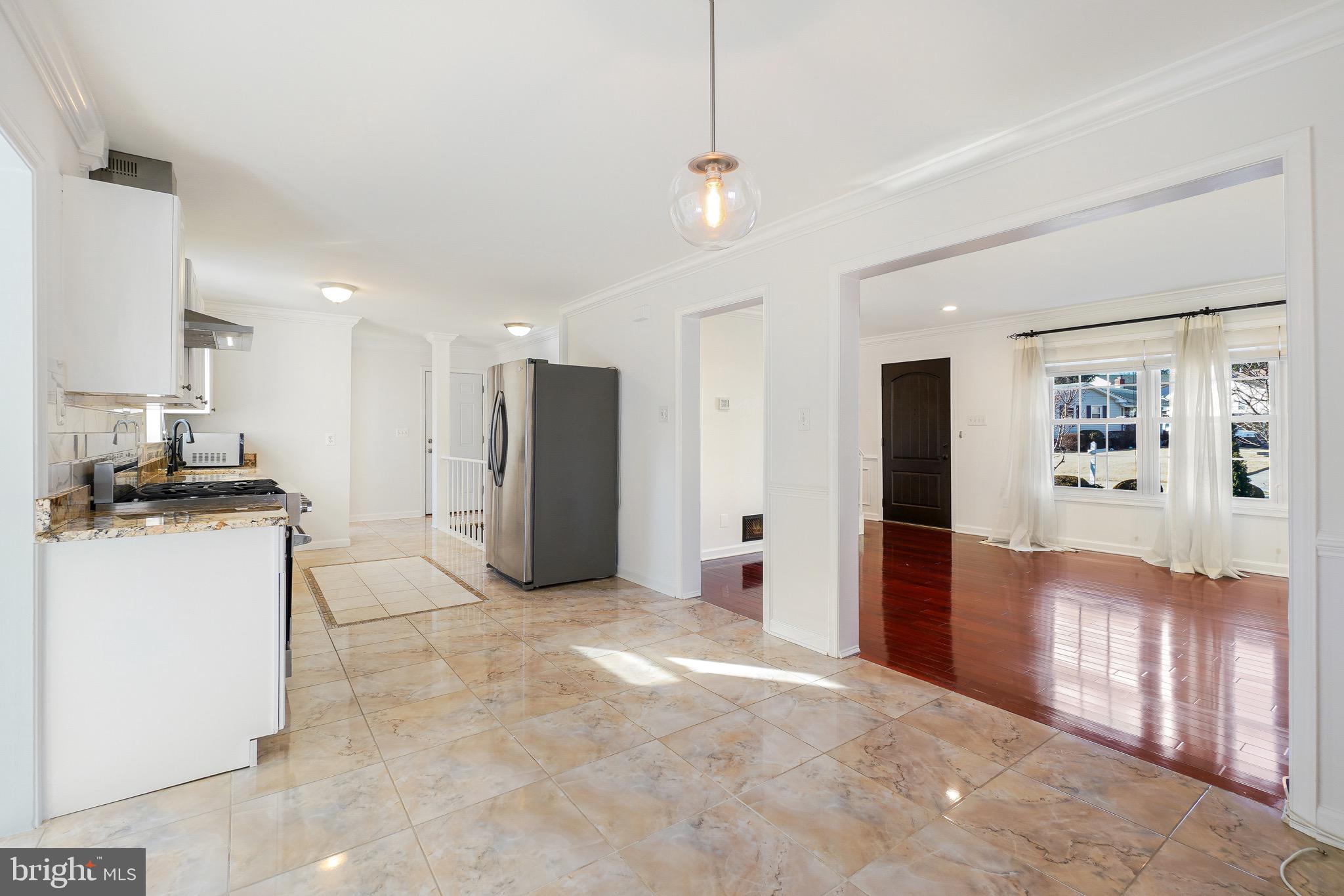 4712 Listra Road Rockville, MD 20853 - Photo 6 of 30 a view of a refrigerator in kitchen and an empty room